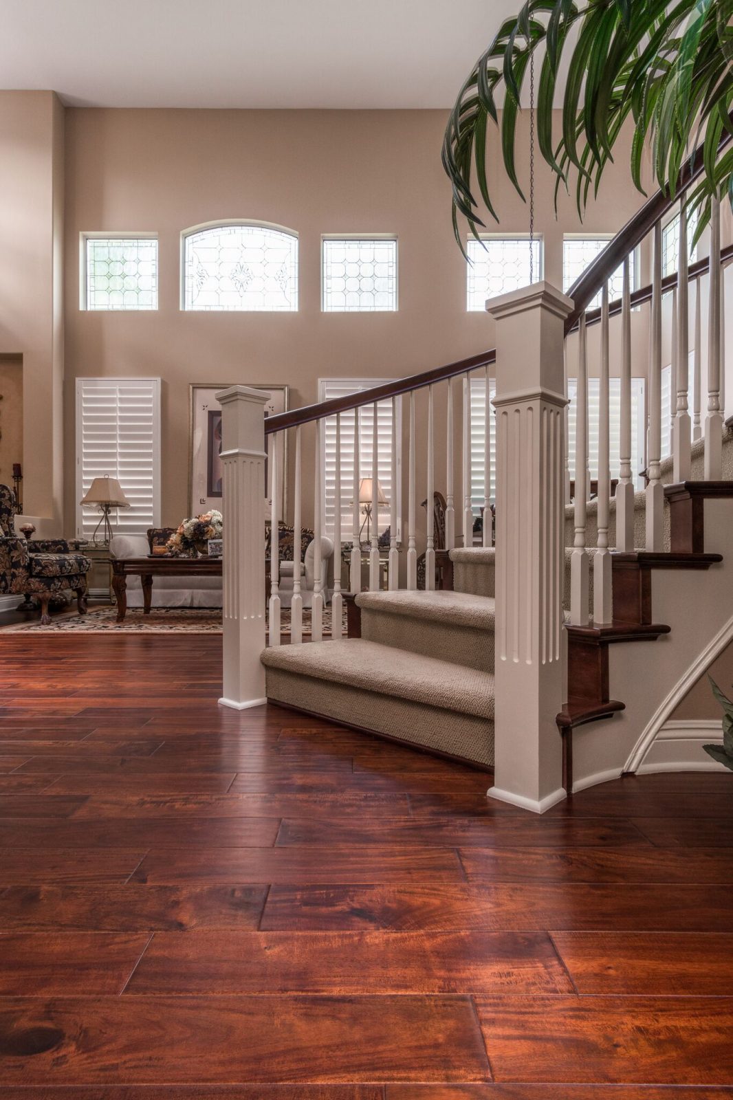 Dark distressed Acacia hardwood floor in a warm transitional living room, Garrison Exotics Bronze 5-inch engineered planks.