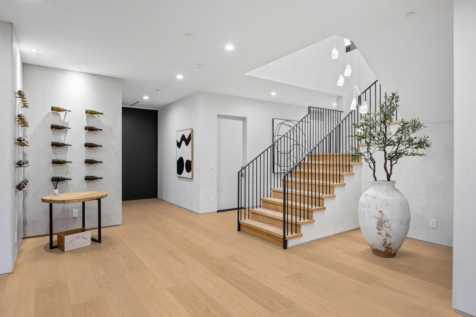 Living room floored in Allora Altura Select European Oak engineered hardwood in a smokey tan finish.