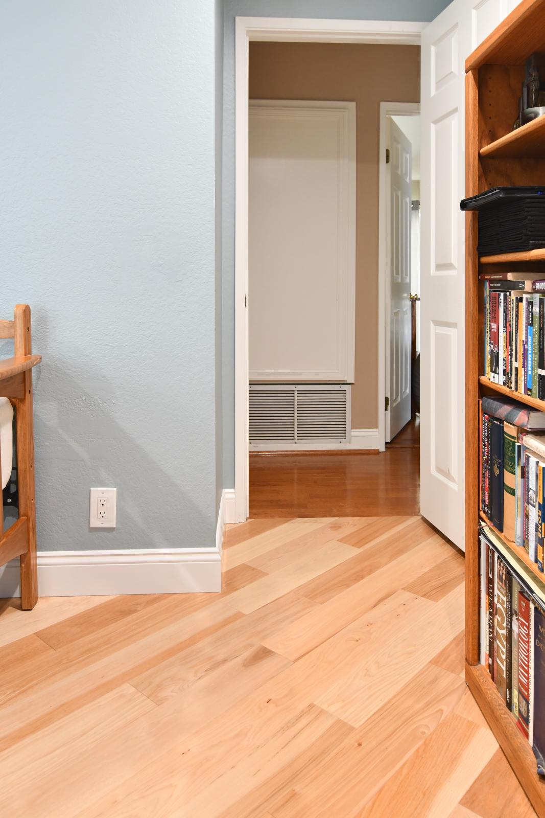 Room scene with Garrison II Smooth Natural Hickory engineered hardwood flooring in a bright, open living space