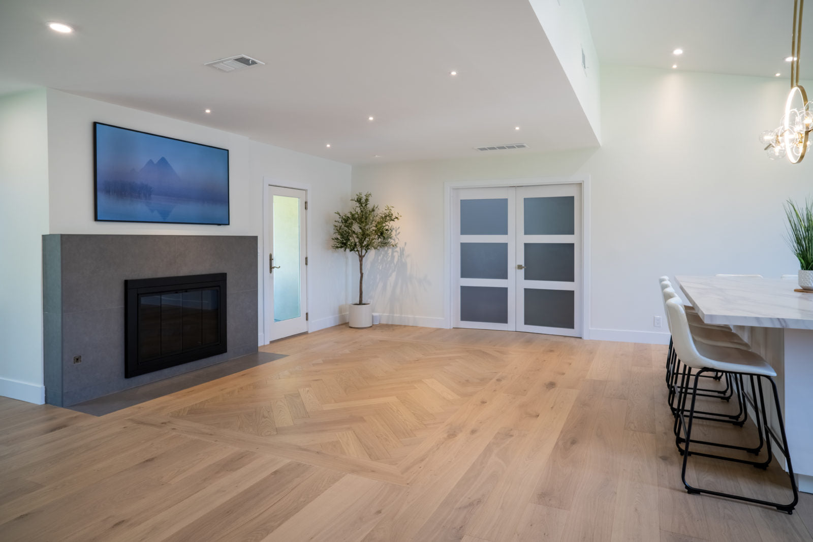 Living room floor featuring Allora Doma Herringbone engineered European Oak flooring in a herringbone pattern.
