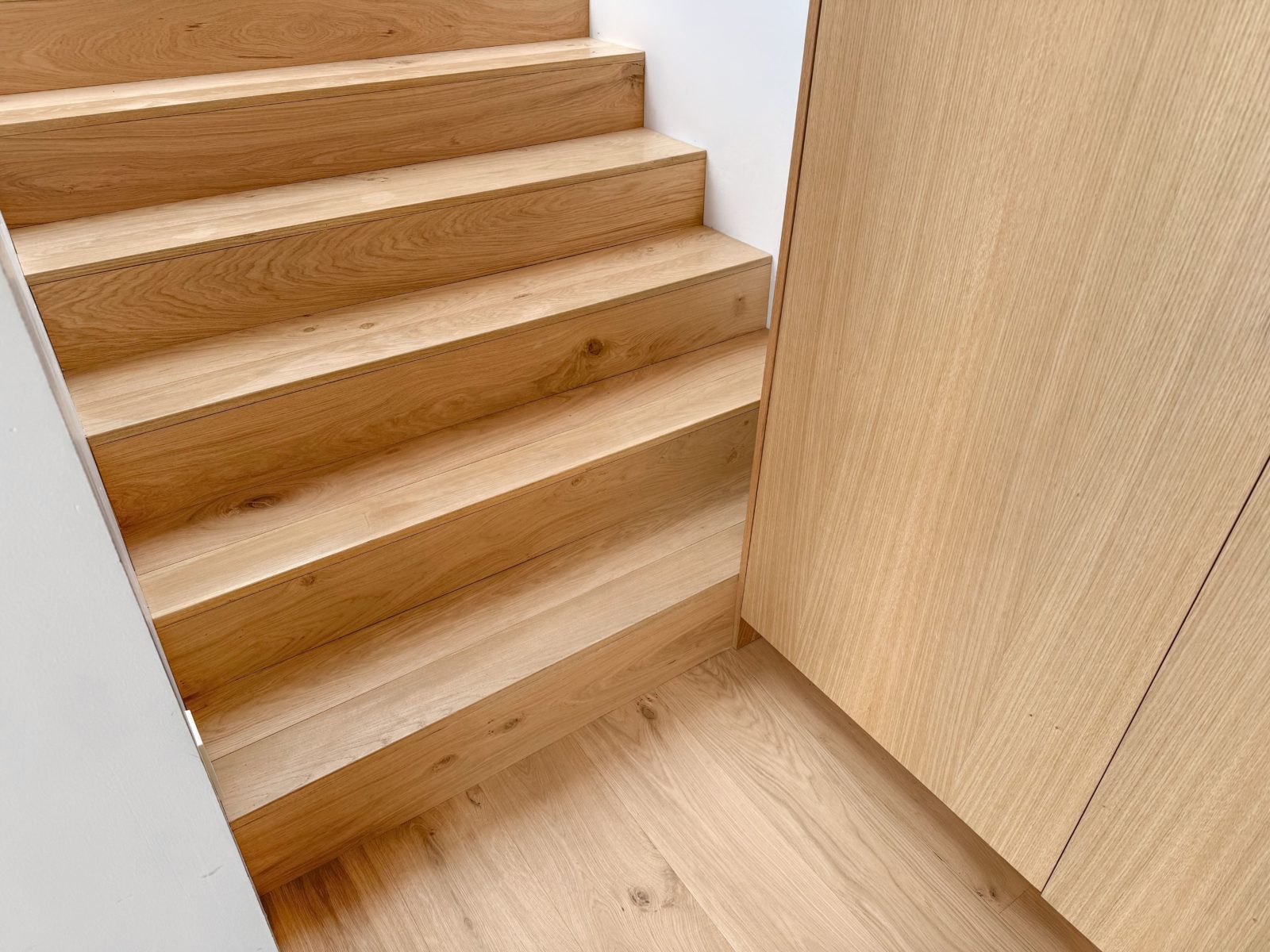 Allora Sella European Oak engineered hardwood flooring installed in a light-filled transitional living room.