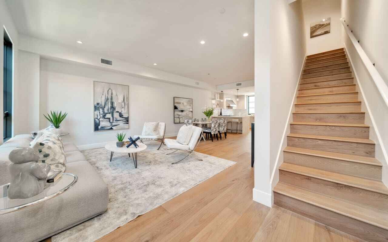 Room scene showing Garrison Newport Laguna Beach wide-plank engineered Oak flooring in a bright, modern living space