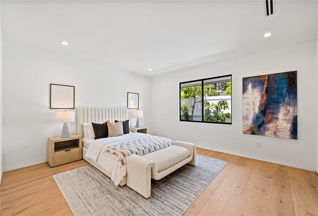 Room scene with Garrison Private Selection Mesa wide-plank engineered hardwood flooring in warm medium oak tone