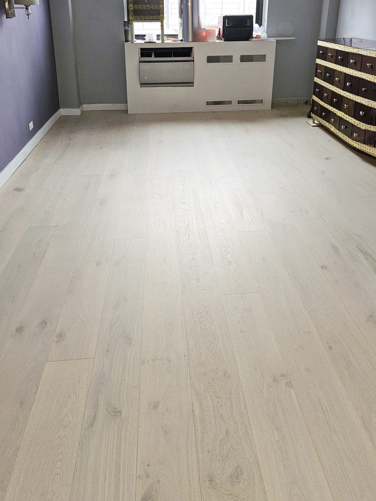 Allora Luna European Oak engineered hardwood flooring installed in a bright, open-plan living room