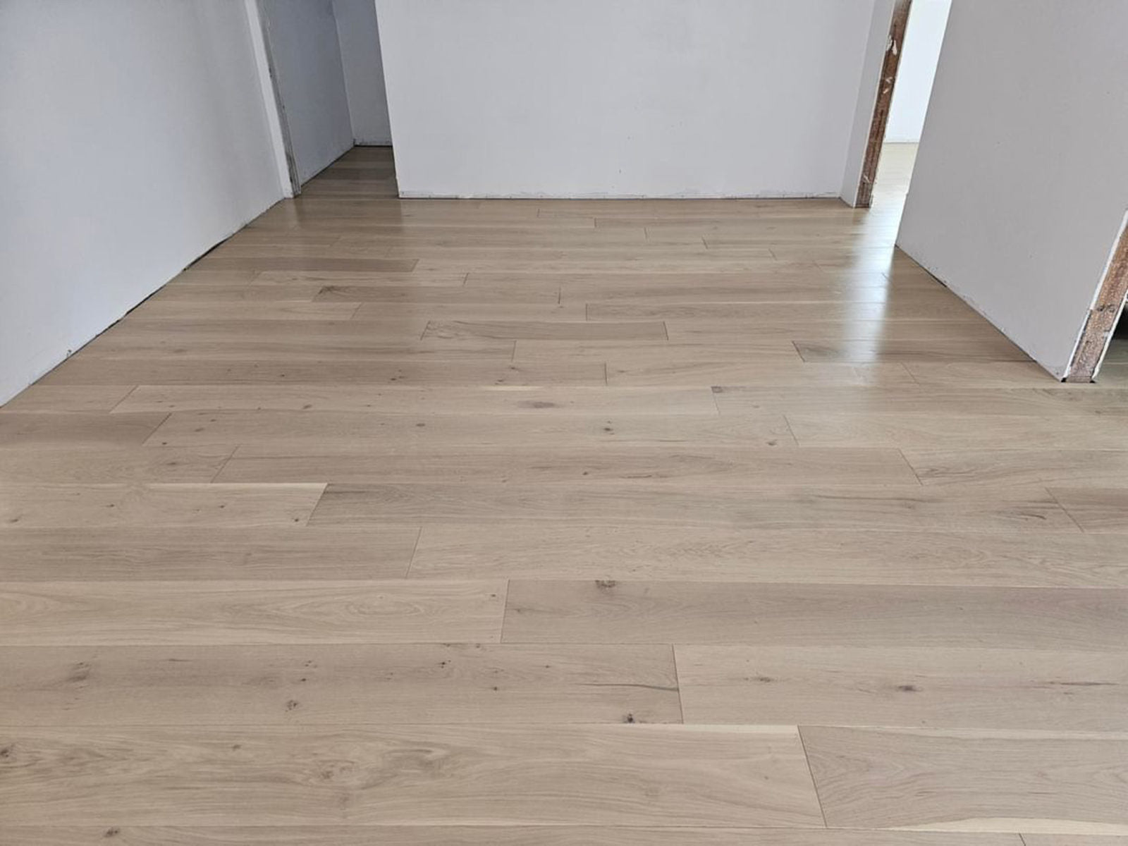 Room scene with Garrison Private Selection Sahara wide-plank European Oak flooring in a warm, modern living space
