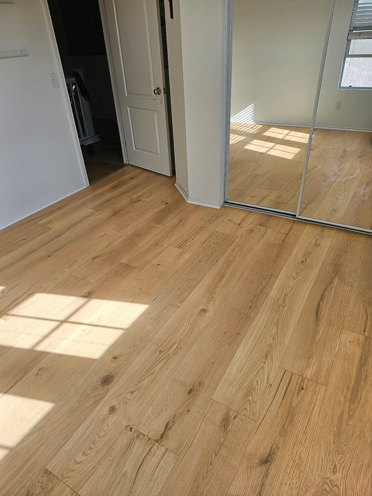 Room scene with Garrison Private Selection Adobe wide-plank European Oak engineered hardwood in a modern interior